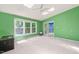 Bright living room with skylights, ceiling fan, and sliding glass doors to the backyard at 3 Cobble Glen Ct, Durham, NC 27713
