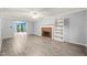 Open-concept living room with fireplace, bookshelf, and seamless flow to sun room at 3 Cobble Glen Ct, Durham, NC 27713