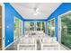 Bright sunroom with blue walls, tile floors, and access to the backyard at 3 Cobble Glen Ct, Durham, NC 27713