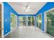 Sunroom features bright blue walls and multiple sliding glass doors to let in the sun at 3 Cobble Glen Ct, Durham, NC 27713