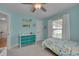 Bright light blue bedroom with a bed, dresser, and plenty of natural light from the windows at 3003 University Dr, Durham, NC 27707