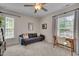 Cozy bedroom features a seating area, desk, and ceiling fan at 3003 University Dr, Durham, NC 27707