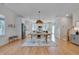 Bright dining room with view of kitchen, stainless appliances, and eat-in breakfast bar at 3003 University Dr, Durham, NC 27707
