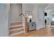 Inviting entryway featuring hardwood floors, stairs, and a charming side table with decor at 3003 University Dr, Durham, NC 27707