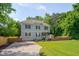 Lovely two-story home with a well-maintained lawn, complemented by mature trees and a quaint shed at 3003 University Dr, Durham, NC 27707