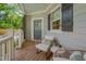 Charming porch featuring comfortable chairs, a side table, and a welcoming ambiance at 3003 University Dr, Durham, NC 27707
