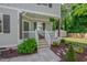 Inviting front porch with seating, offers a cozy spot to relax and enjoy the landscaped surroundings at 3003 University Dr, Durham, NC 27707