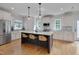 Stylish kitchen features an island, stainless appliances, sleek white cabinets, and a breakfast bar at 3003 University Dr, Durham, NC 27707