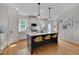 Well-appointed kitchen with island, breakfast bar, stainless appliances, and white cabinets at 3003 University Dr, Durham, NC 27707