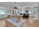 Eat-in kitchen area features wood table, decorative rug, stainless appliances, and white cabinetry at 3003 University Dr, Durham, NC 27707