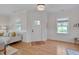 Bright living room with natural light, features a cozy sofa, windows, and neutral decor at 3003 University Dr, Durham, NC 27707
