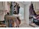 Well-organized walk-in closet with hanging rods, shelving, and a window for natural light at 3003 University Dr, Durham, NC 27707