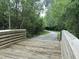 Wooden bridge along the Greenway trail, offering a scenic pathway through the lush green surroundings at 3034 Winfred Dell Ln, Cary, NC 27511