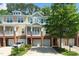 Charming townhome featuring a brick facade, attached garage, and second-story balcony at 3034 Winfred Dell Ln, Cary, NC 27511