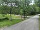 Paved path along the Greenway trail, winding through lush greenery and trees at 3034 Winfred Dell Ln, Cary, NC 27511