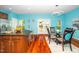 Open kitchen with island flows into dining area, featuring a large island, hardwood floors, and natural light at 3034 Winfred Dell Ln, Cary, NC 27511