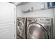 Laundry room with stainless steel washer and dryer, and wire shelving at 3034 Winfred Dell Ln, Cary, NC 27511