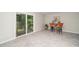 Bright living room with plush carpet, sliding glass doors to backyard, and bar seating at 3034 Winfred Dell Ln, Cary, NC 27511