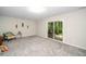 This room features plush carpet, sliding glass doors, and vintage-style decor with unique light fixture at 3034 Winfred Dell Ln, Cary, NC 27511