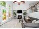 Bright living room with fireplace, soaring ceilings, and access to outdoor living space at 3034 Winfred Dell Ln, Cary, NC 27511