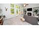 Bright living room features a fireplace, soaring windows, and comfortable seating at 3034 Winfred Dell Ln, Cary, NC 27511