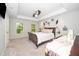 View of main bedroom with tray ceilings, ceiling fan and ensuite bathroom at 3034 Winfred Dell Ln, Cary, NC 27511