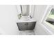 Modern bathroom featuring a gray vanity, undermount sink, marble floors and a large mirror at 309 Beacon Dr, Pittsboro, NC 27312