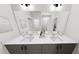 Double vanity bathroom with gray cabinets, white countertop, and large mirrors for a clean, modern aesthetic at 309 Beacon Dr, Pittsboro, NC 27312