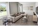 Comfortable living room with a sectional sofa, multiple windows, and stylish decor, ideal for gatherings and relaxation at 309 Beacon Dr, Pittsboro, NC 27312