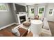 Inviting living room features a fireplace, large windows, and comfortable seating, perfect for relaxation at 309 Beacon Dr, Pittsboro, NC 27312