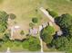 Aerial view of the home and lot, surrounded by mature trees and outbuildings at 319 Knox Rd, Gibsonville, NC 27249