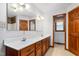 Functional bathroom featuring a double sink vanity with wood cabinets and a large mirror at 319 Knox Rd, Gibsonville, NC 27249