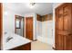Traditional bathroom with double sink vanity, bathtub, and separate door for added privacy at 319 Knox Rd, Gibsonville, NC 27249