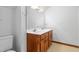 Clean bathroom featuring double sinks, a vanity with wooden cabinets and hardware, and tiled floors at 319 Knox Rd, Gibsonville, NC 27249