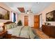 Bedroom featuring hardwood floors, ceiling fan, doors to other rooms, and an airy feel at 319 Knox Rd, Gibsonville, NC 27249