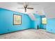 Bright blue bedroom featuring a ceiling fan, hardwood floors, and ample natural light, creating a vibrant atmosphere at 319 Knox Rd, Gibsonville, NC 27249
