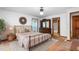 Comfortable bedroom featuring a bed and dresser, complemented by natural light from the window at 319 Knox Rd, Gibsonville, NC 27249