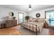 Main bedroom with a neutral color palette, decorative mirrors, and a large window at 319 Knox Rd, Gibsonville, NC 27249