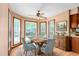 Sunlit dining area with a rustic wood table, comfortable seating, and bay windows at 319 Knox Rd, Gibsonville, NC 27249