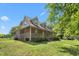 Charming two-story brick home with a large wrap-around porch and dormer windows at 319 Knox Rd, Gibsonville, NC 27249