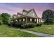 Charming two-story brick home with a large wrap-around porch and dormer windows at 319 Knox Rd, Gibsonville, NC 27249
