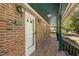 Inviting front porch with outdoor seating, lighting, and view of the front yard at 319 Knox Rd, Gibsonville, NC 27249