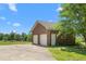 Spacious three-door brick garage with a large driveway, offering ample parking and storage at 319 Knox Rd, Gibsonville, NC 27249