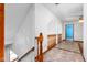 Upper hallway featuring wooden banisters and an open view to the downstairs living areas at 319 Knox Rd, Gibsonville, NC 27249