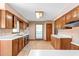 Traditional kitchen showcasing wood cabinetry, white countertops, and wood-look flooring at 319 Knox Rd, Gibsonville, NC 27249