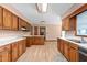 Spacious kitchen with wood cabinets, white countertops, and wood-look flooring at 319 Knox Rd, Gibsonville, NC 27249