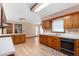 Open kitchen layout with wood cabinets, white countertops, and view of the breakfast nook at 319 Knox Rd, Gibsonville, NC 27249