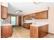 Traditional kitchen with wood cabinets, white countertops, and wood-look flooring at 319 Knox Rd, Gibsonville, NC 27249