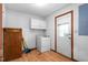 Functional laundry room with washer, dryer, and overhead storage at 319 Knox Rd, Gibsonville, NC 27249