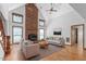 Cozy living room features a striking brick fireplace, plush seating, and ample natural light at 319 Knox Rd, Gibsonville, NC 27249